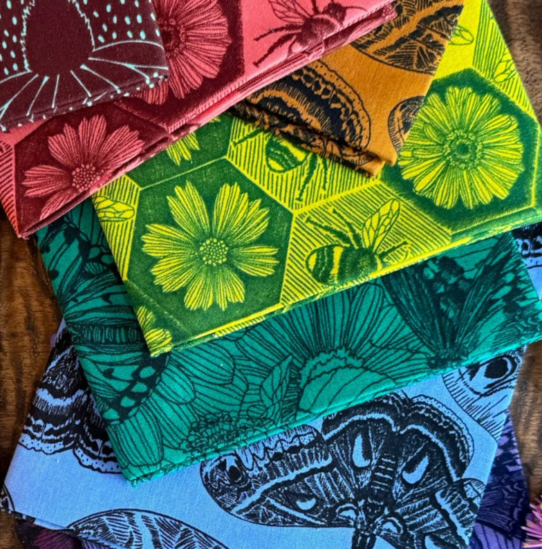 Anna Maria Textiles fat quarter bundles in vibrant multicolor floral prints stacked together.